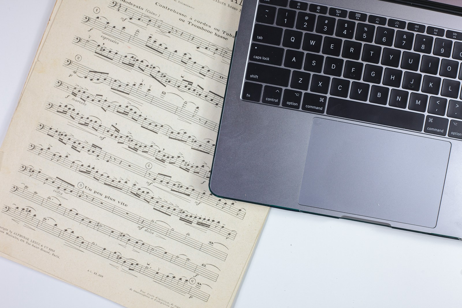 Printed documents next to a laptop, representing searchable AI call transcripts