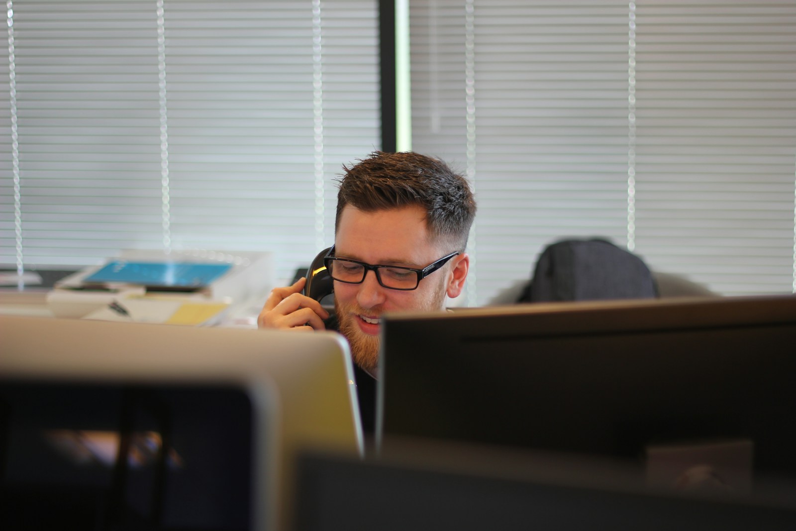 Why AI phone systems are the future of business communication Professional using a desk IP phone, the kind of business communication AI phone systems are replacing