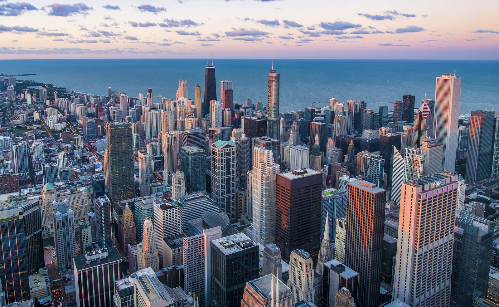 24/7 answering service — AI Phone 360 City skyline at dusk where a 24/7 answering service keeps business phone lines covered