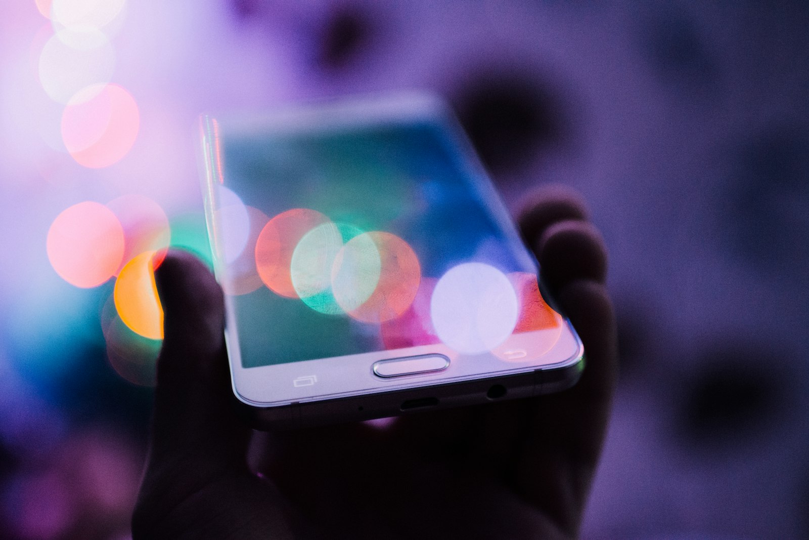 After-hours answering service — AI Phone 360 Customer holding a smartphone at night while an after-hours answering service picks up the call
