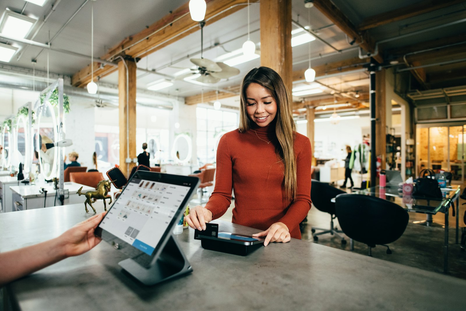 Answering service for small business — AI Phone 360 Small business front counter where staff help a customer while the answering service handles calls